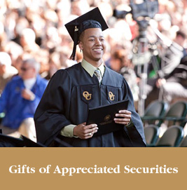 A proud student holding his diploma. Gifts of Appreciated Securities